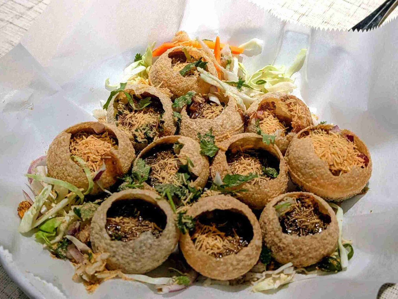 Sev Puri — Tiny crispy flat puris loaded with potato, onion, three chut