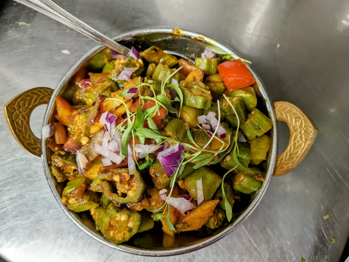 Bhindi Masala – Tender okra stir-fried with onion, tomato, and aromatic spices in a kadhai | SPICE ROOM Denver