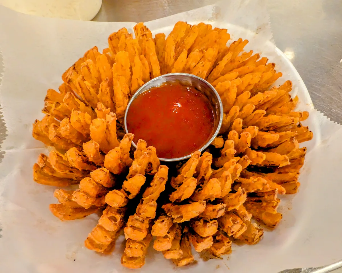 Blooming Onion – Whole onion fried into a crispy flower — our iconic shareable appetizer with dipping sauce | SPICE ROOM Denver