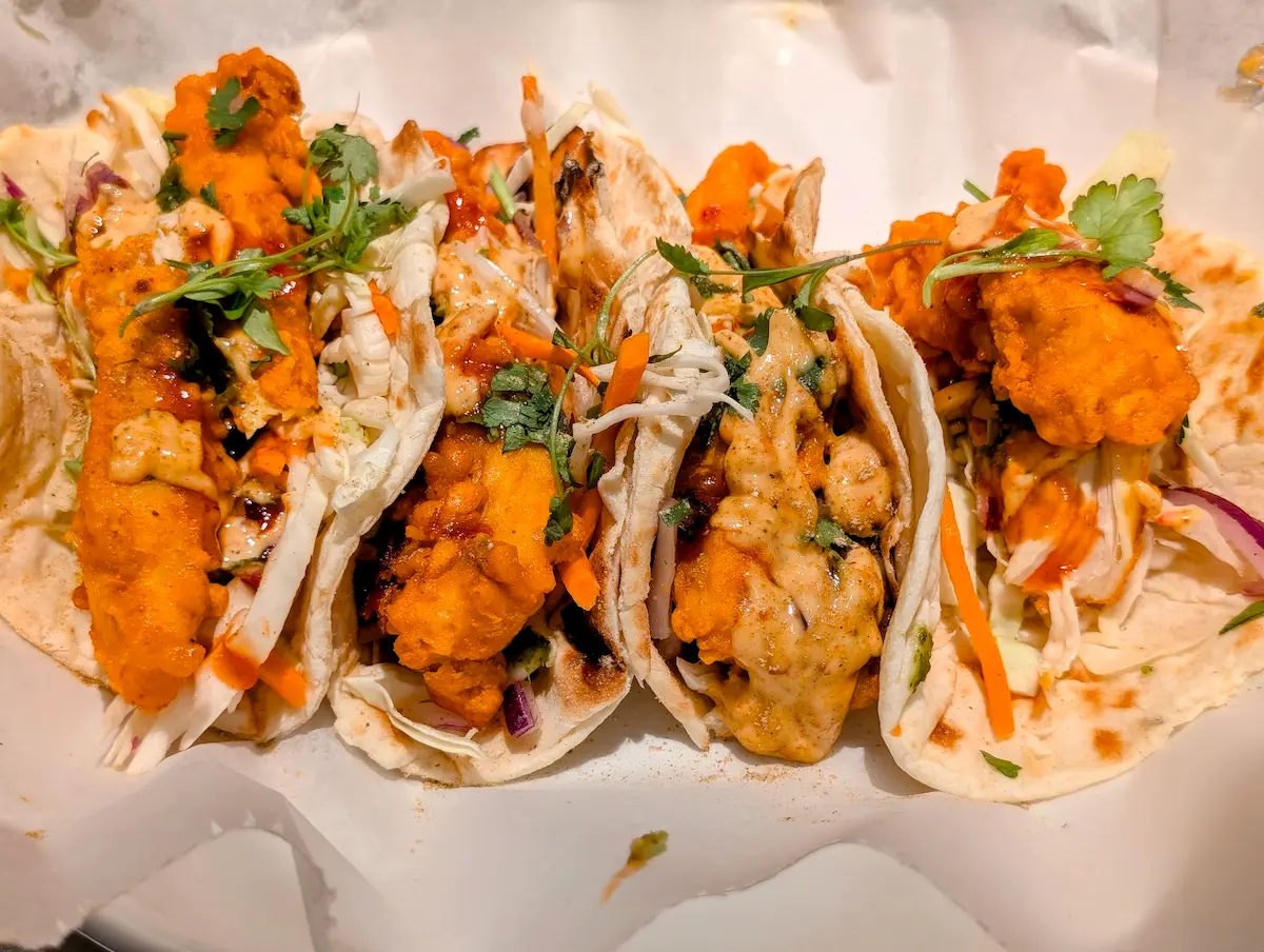 Chicken Pakora Tacos – Crispy pakora-battered chicken in soft naan wraps with tangy slaw and chutney drizzle | SPICE ROOM Denver