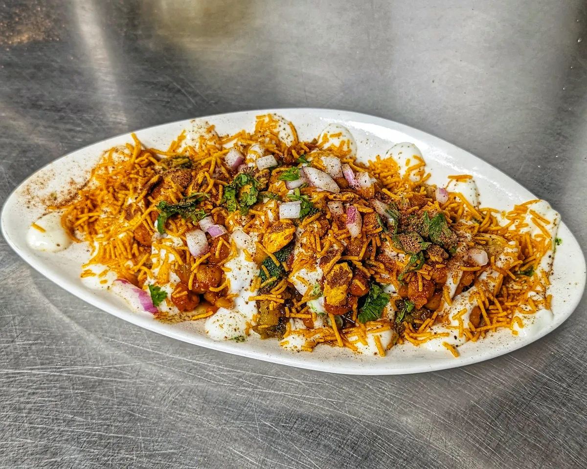 Dahi Chaat – Crispy chickpeas and potato over cool yogurt, topped with sev and chaat masala | SPICE ROOM Denver