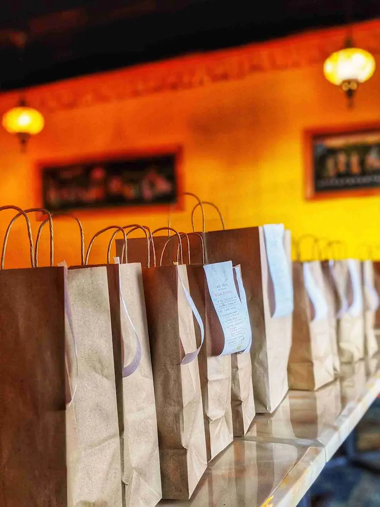 SPICE ROOM delivery and pickup bags lined up ready to go