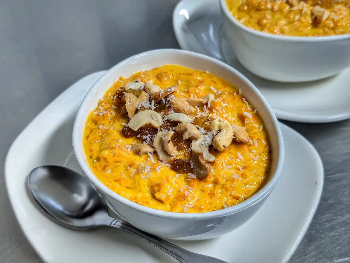 Gajar Halwa – Classic Indian carrot pudding topped with cashews, raisins, and coconut | SPICE ROOM Denver