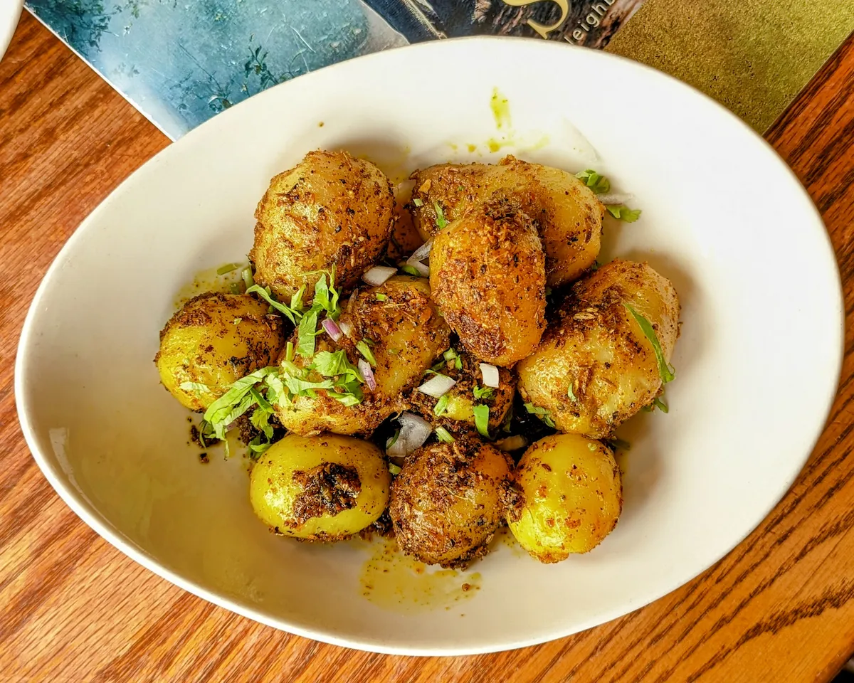 Jeera Aloo – Golden potatoes tossed with cumin, herbs, and warming spices | SPICE ROOM Denver