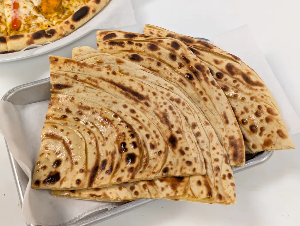 Paratha Stack – Flaky, layered whole-wheat parathas — buttery and freshly pressed off the tava | SPICE ROOM Denver
