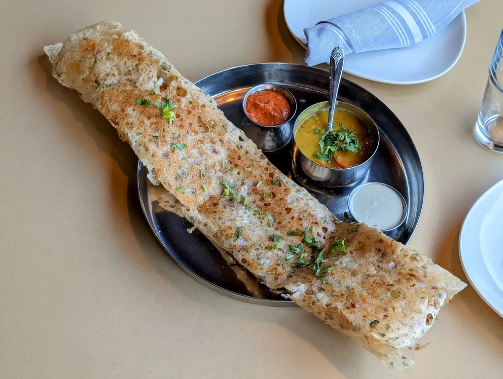 Rava Dosa – Crispy semolina crepe with a lacy, golden texture — served with sambar and chutneys | SPICE ROOM Denver