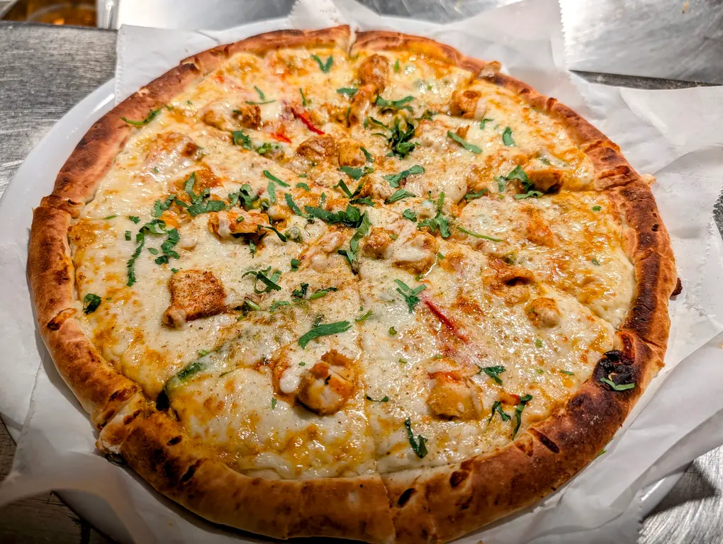 Tikka Pizza (Whole) – Full-size Indo-Italian fusion pizza with tikka chicken, herbs, and melted mozzarella | SPICE ROOM Denver