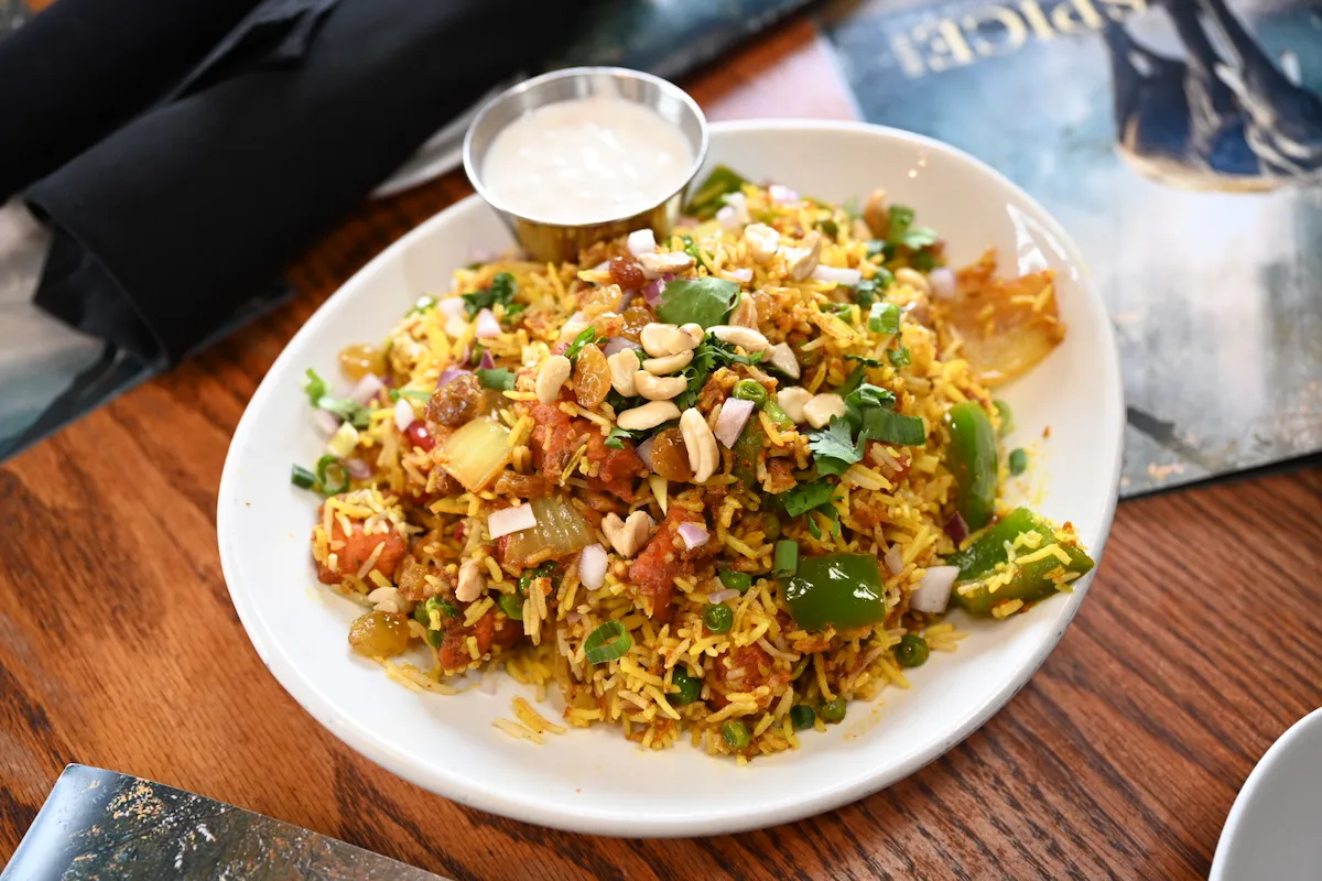 Vegetable Biryani – Fragrant basmati rice layered with seasonal vegetables, nuts, and whole spices | SPICE ROOM Denver