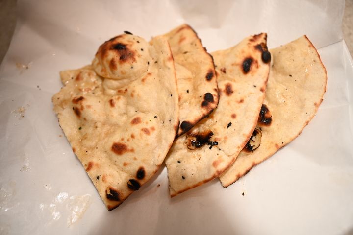 Butter Naan — Pillow-soft bread from our 500°F tandoor, blistered and beau
